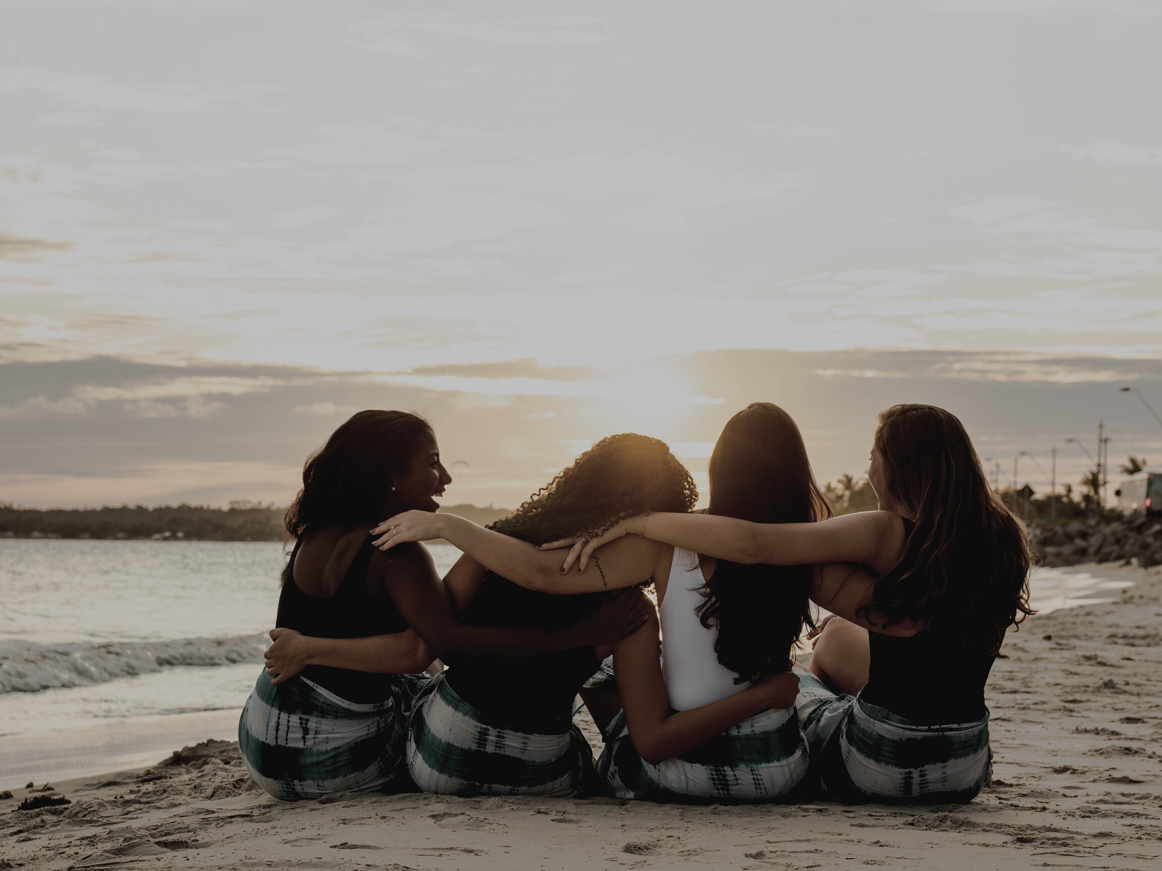 Back View of a Group of Women Sitting on the Beach